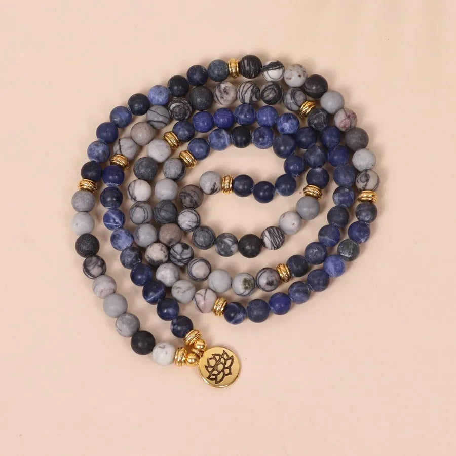 Multi-layer blue bracelet with patterned network stone beads on an alloy chain, natural style.