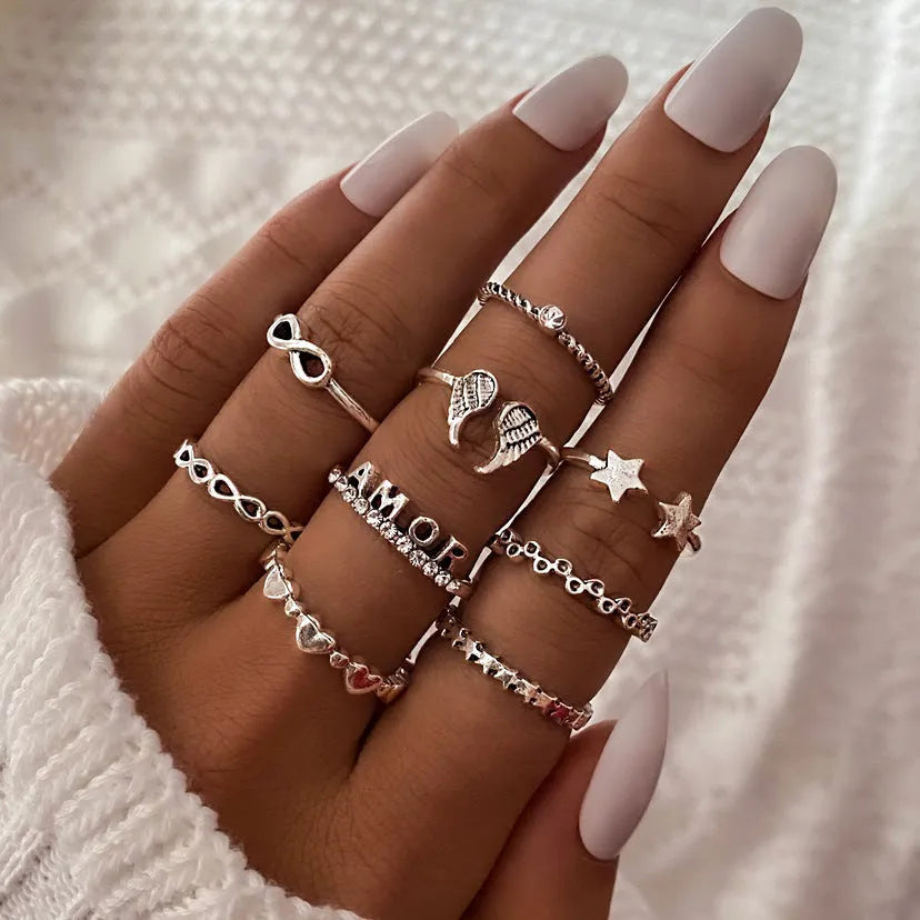 Alloy ring set with butterfly and snake retro geometric designs on display