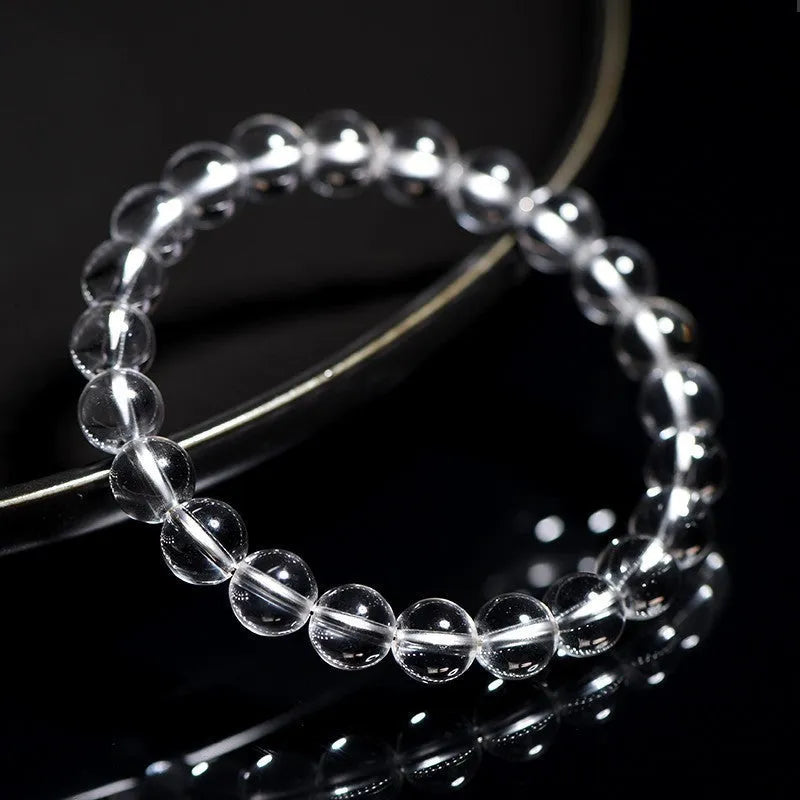 Natural old mine white crystal round bead bracelet with geometric style on a wrist.