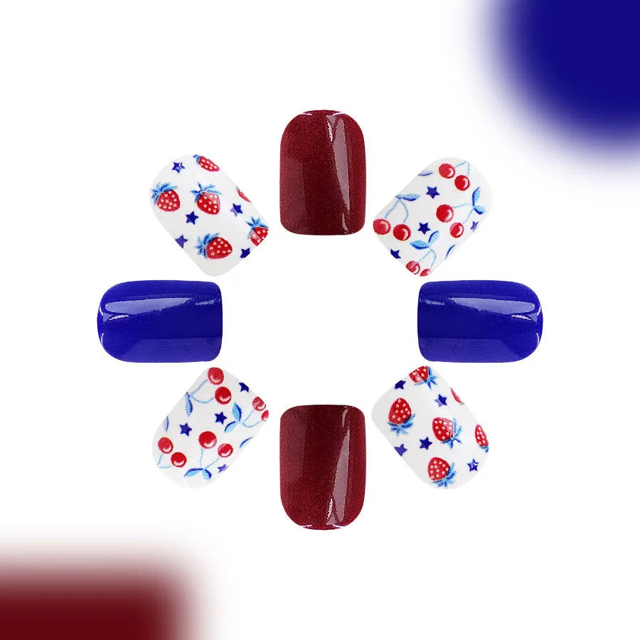 Short glossy false nails with red and blue strawberry cherry pattern, 24 piece set.