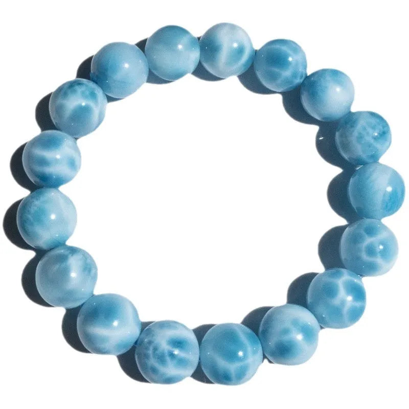 Blue hand-crafted bodhi bracelet with a pearl accent, showing bead sizing options.