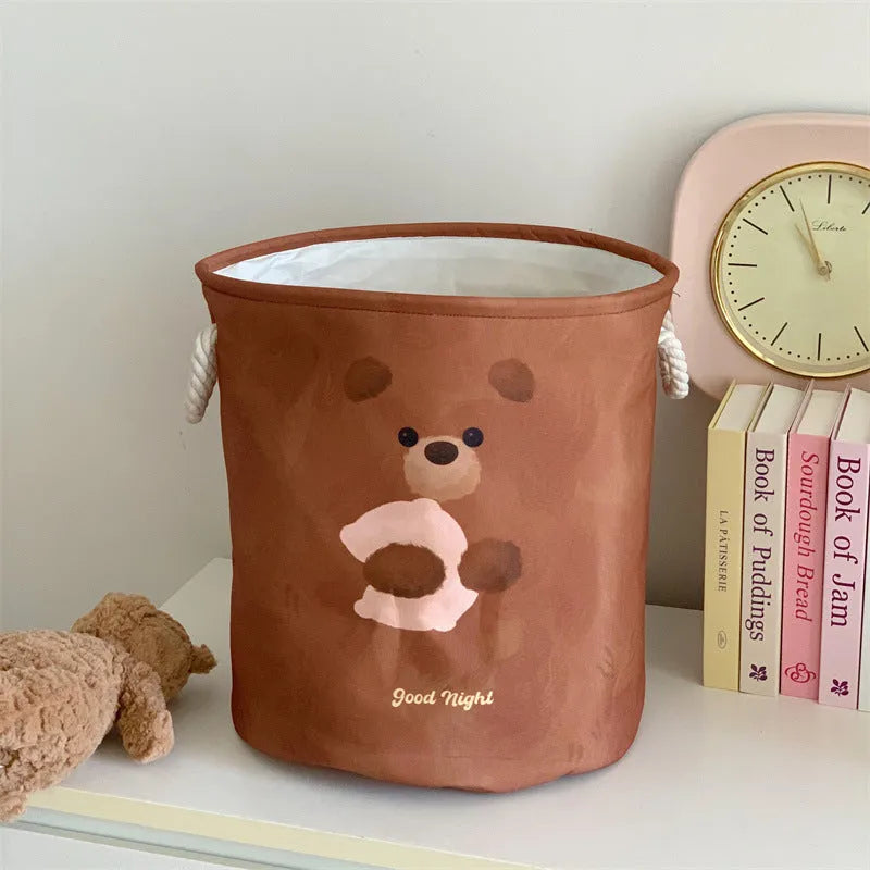 Foldable cotton cloth laundry basket in a character print colour, shown unfolded for use.