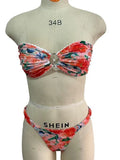 Floral printed lace bikini top in blue, shown as a sleeveless, backless tube top for swimming.