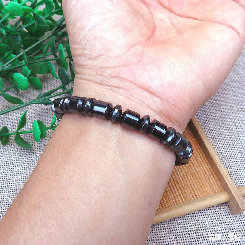 Black pentagram symbol magnetic bracelet with magnetite and hematite stones on a stretch band.