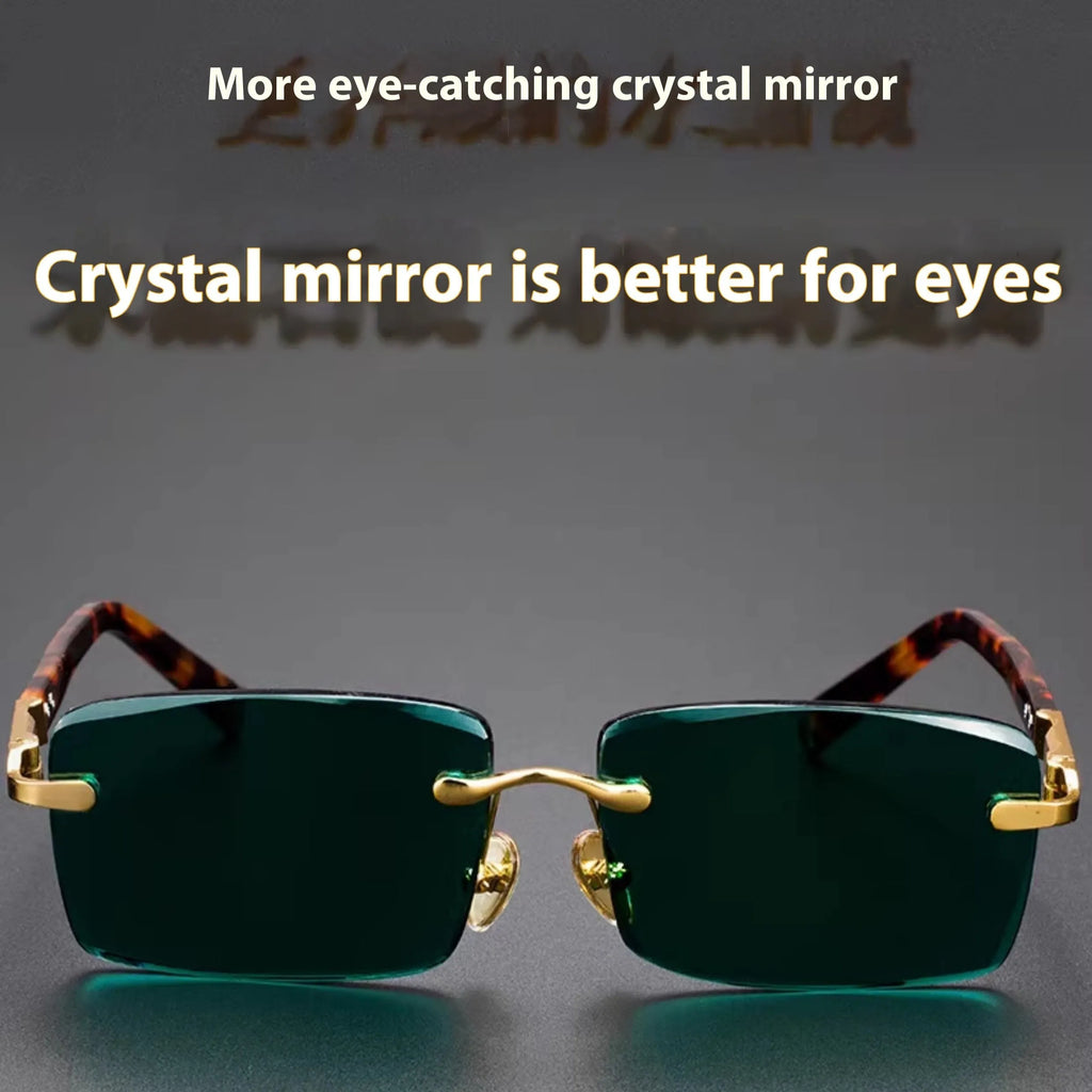 Frameless dark green crystal lens sunglasses with adjustable nose pads on a table next to their hard case.