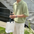 A caramel coloured men's loose-fit knitted polo shirt with short sleeves on a hanger.