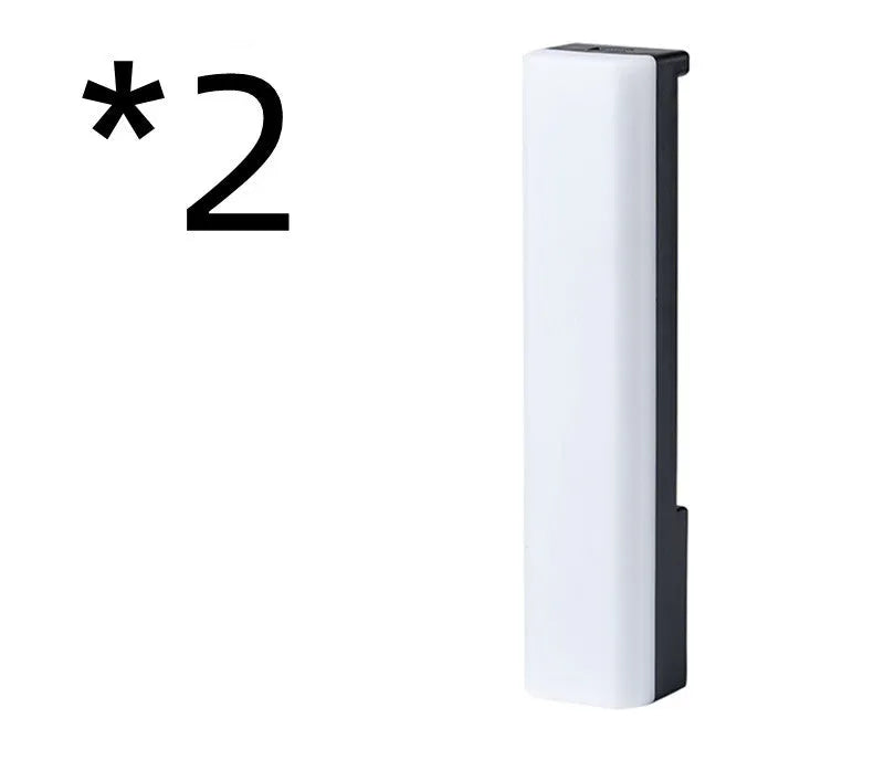 A tall, colourful RGB table lamp with a white or black shell reacting to sound on a desk.