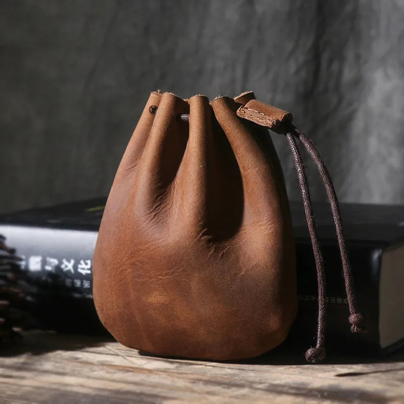 Vintage cowhide leather drawstring pouch wallet in black shown open and closed