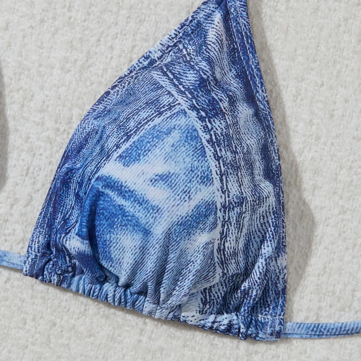 Denim blue printed women's bikini set with strap detailing on a white background.