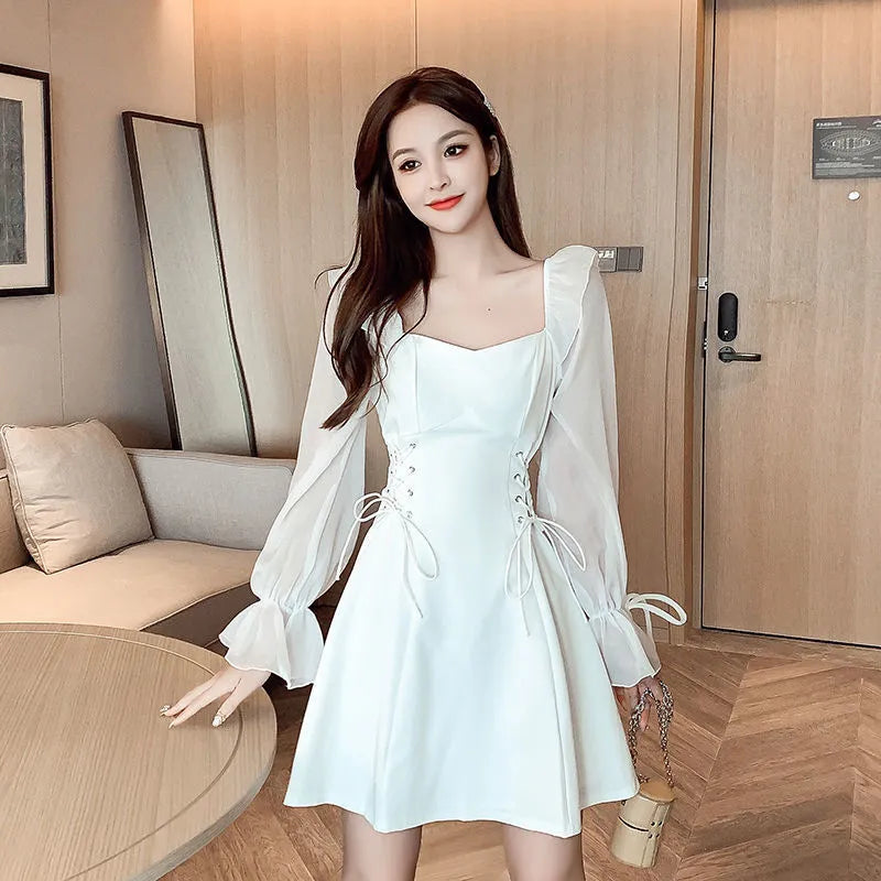 White waist-slimming chiffon patchwork dress with long sleeves on a woman.