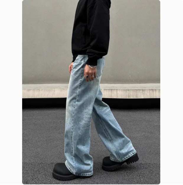 Men's blue straight leg jeans with whisker washing and visible stitching detail
