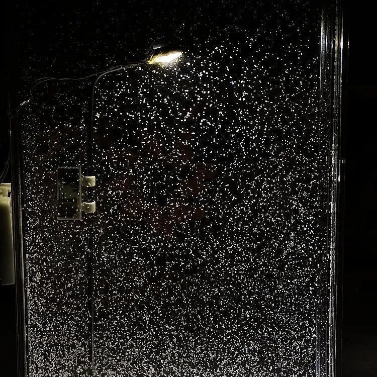 Assembled DIY snowy landscape night light with small street light and warm LED glow on a desktop.