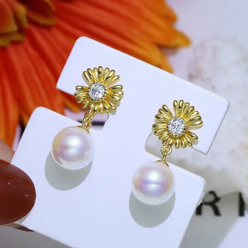 A pair of Baroque-style floral earring frames made of sterling silver, featuring a small integrated ring holder, presented without pearls.