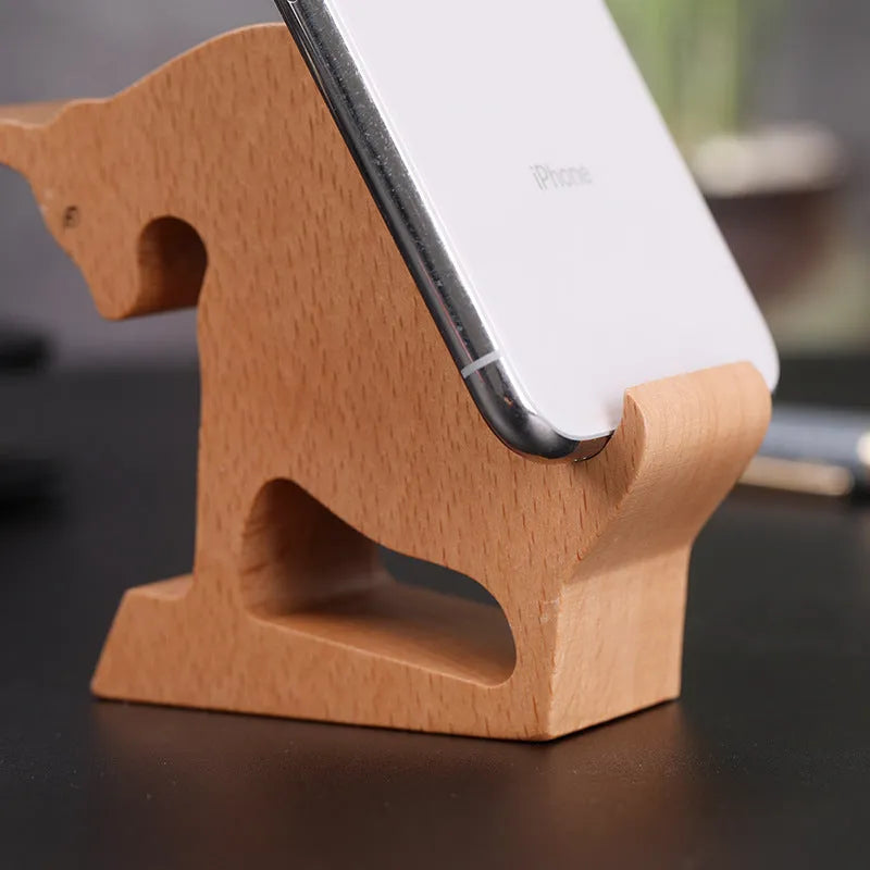 Solid beech wood phone holder with resin puppy decoration and a pound coin in the integrated slot.