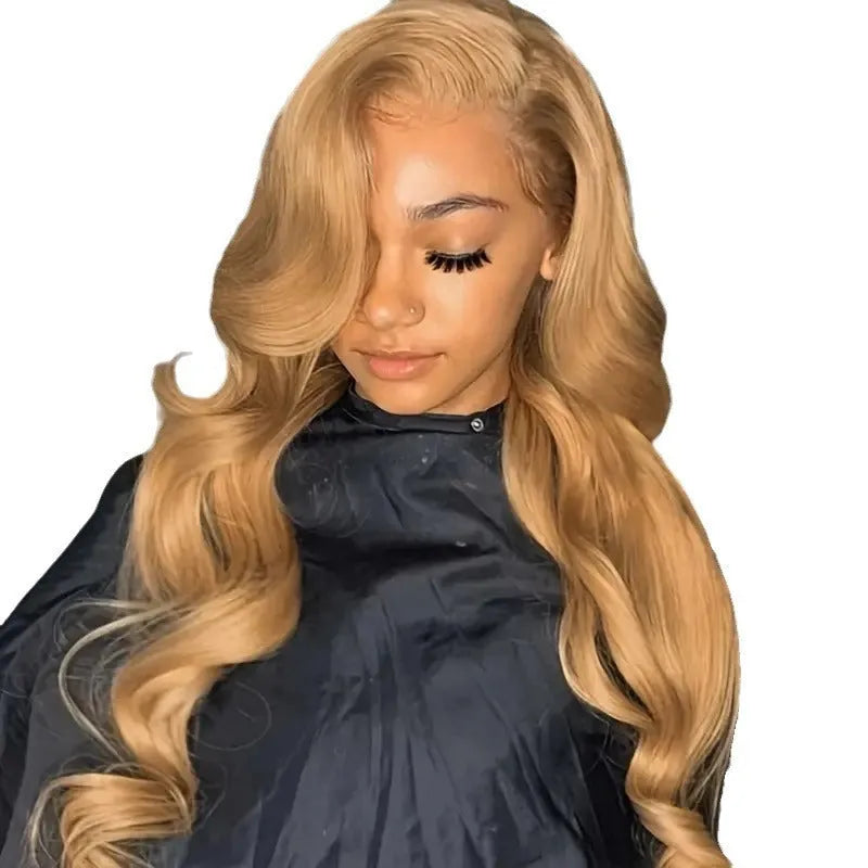 Long golden light brown synthetic wig with big curly waves and side bangs laid flat.