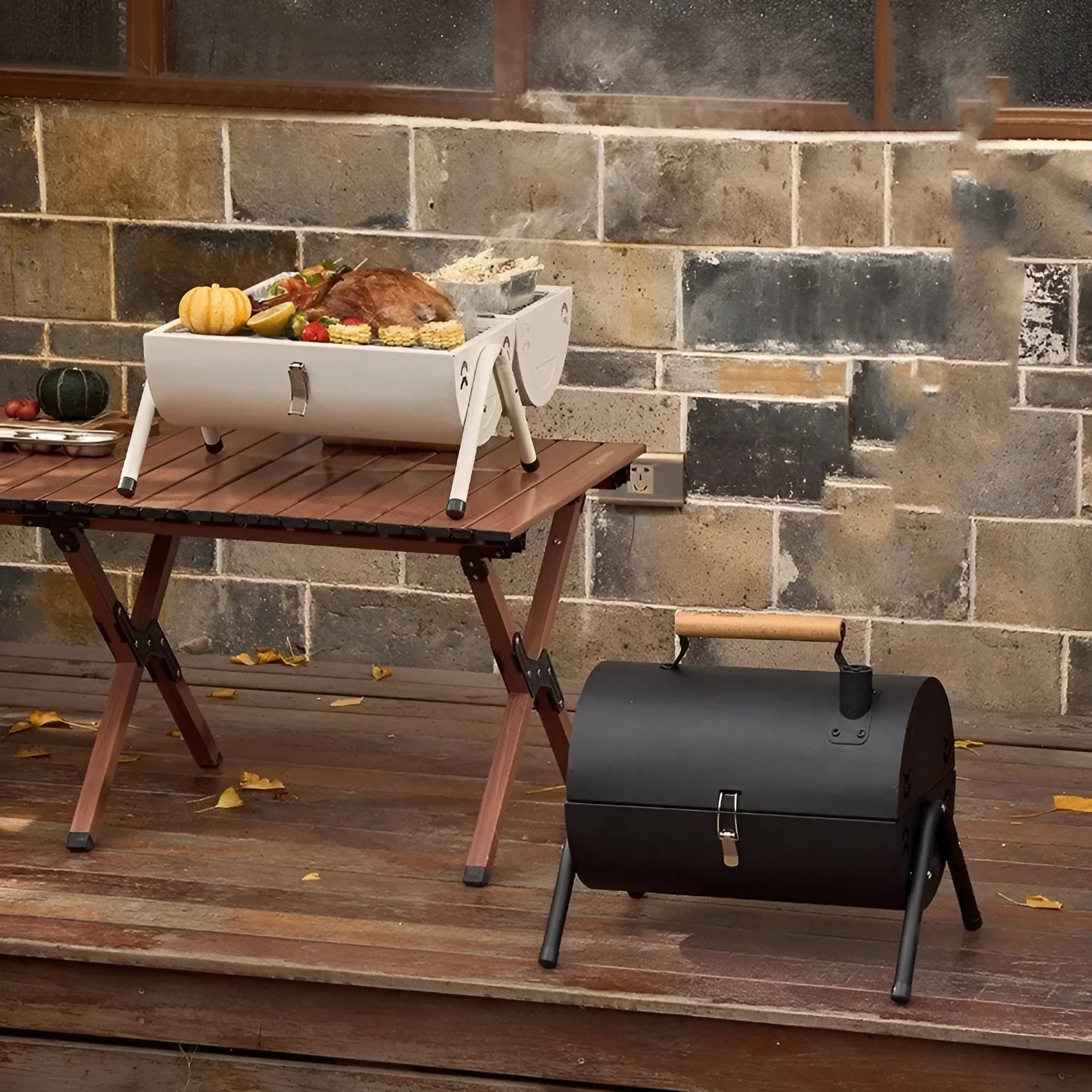 White round chimney portable charcoal grill with foldable legs, two carbon tanks, and a dual cooking mesh setup.