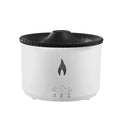 White flame and blue volcano humidifier diffuser with remote control on a table