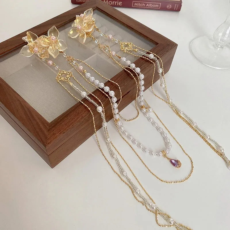 Gold tone acrylic hairpin with pearl diamond flowers and long tassel design