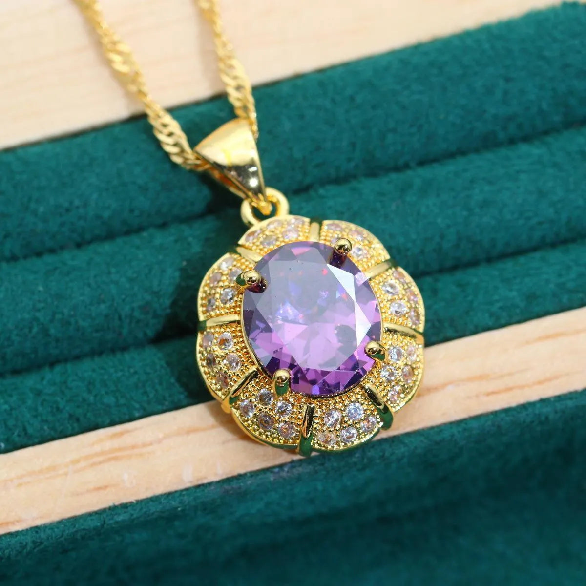 18k gold-plated necklace, bracelet, earrings, and ring set with blue cubic zirconia stones.