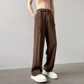 Model wearing thin black straight wide leg casual trousers with a loose fit.
