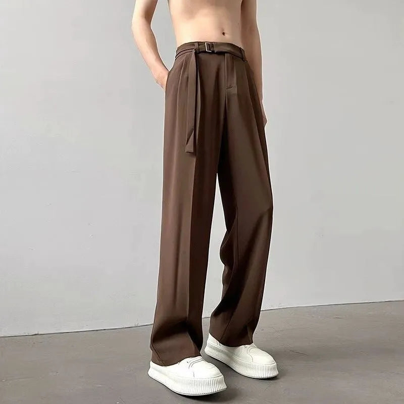 Model wearing thin black straight wide leg casual trousers with a loose fit.