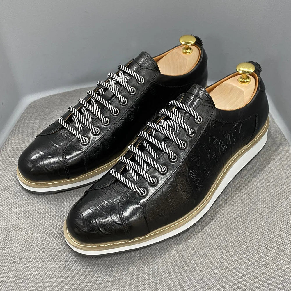 Men's low-top handmade shoes with embossed pattern on upper, shown in black with front tie laces.