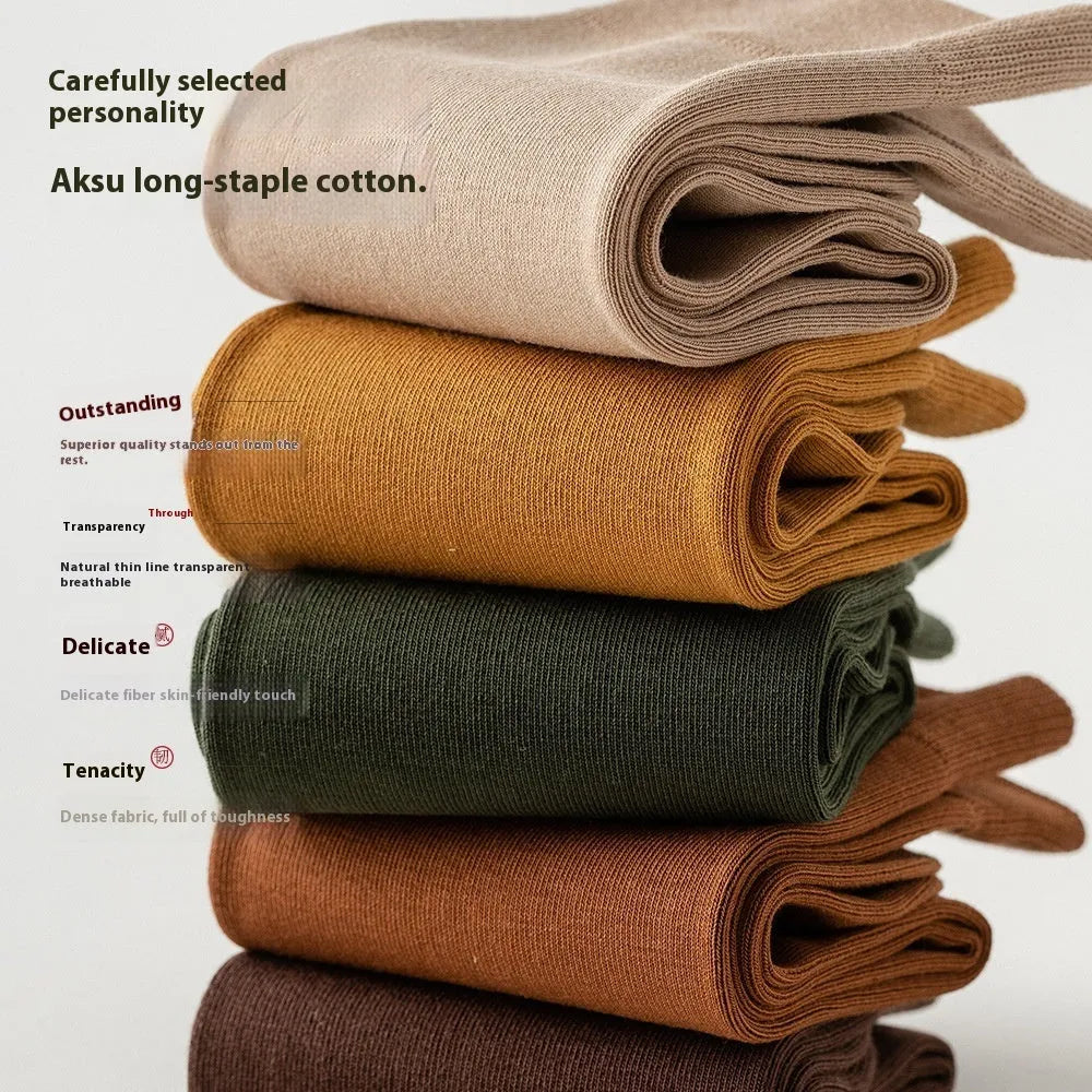 Five pairs of men's solid colour mid-calf socks made from combed cotton, shown in assorted colours.