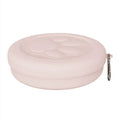 Foldable green and pink portable dog bowl showing open food and water compartments and closed flat profile