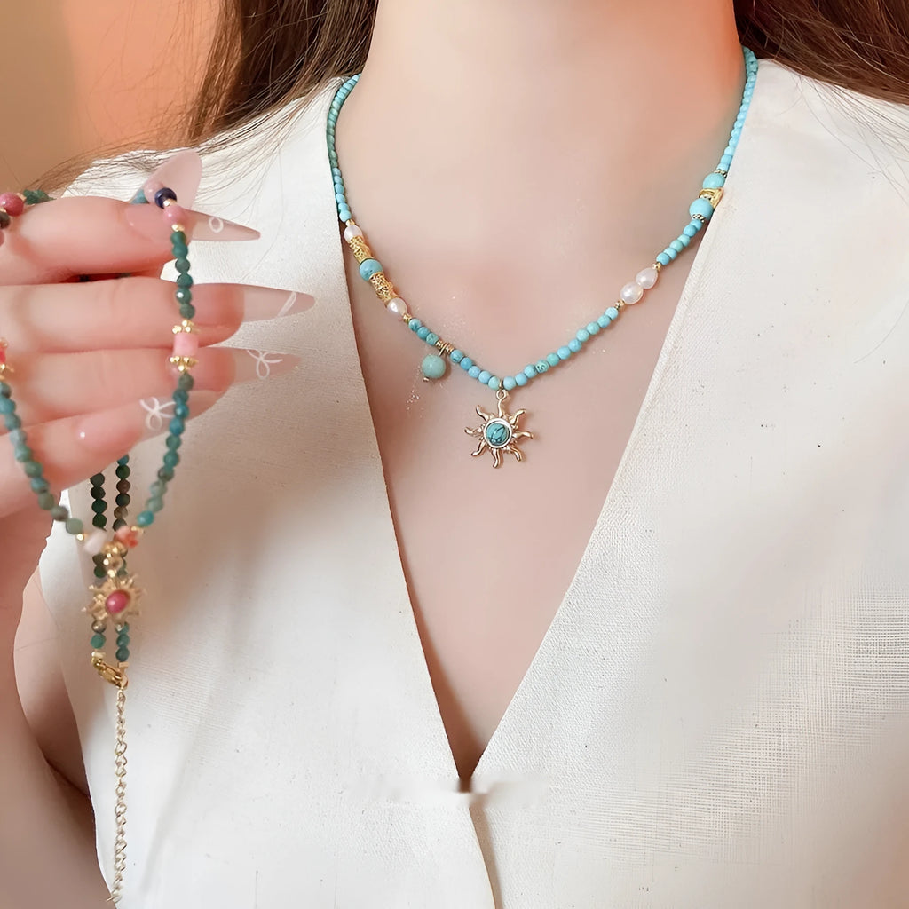 Freshwater pearl necklace with blue sun stone pendant on an adjustable clavicle chain.