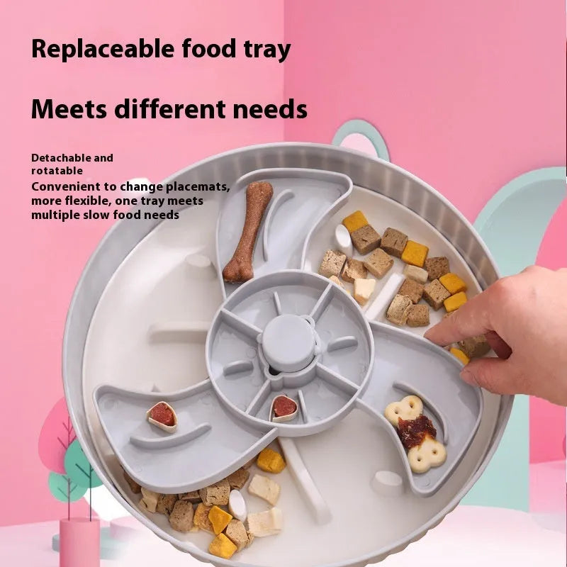 Grey plastic slow feeder pet bowl with windmill pattern and white non-slip silicone base on a kitchen floor.