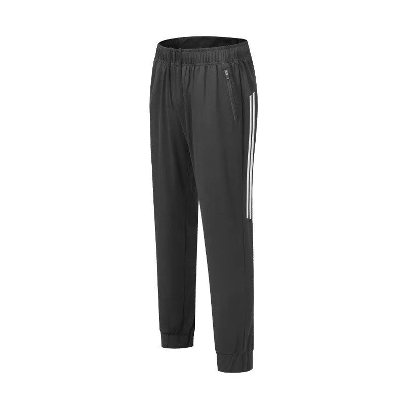 Black men's running trousers with a mid waist, laid flat to show the trousers length and sporty design.