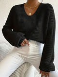 Women's solid colour long sleeve loose pullover in polyester fabric on a hanger.