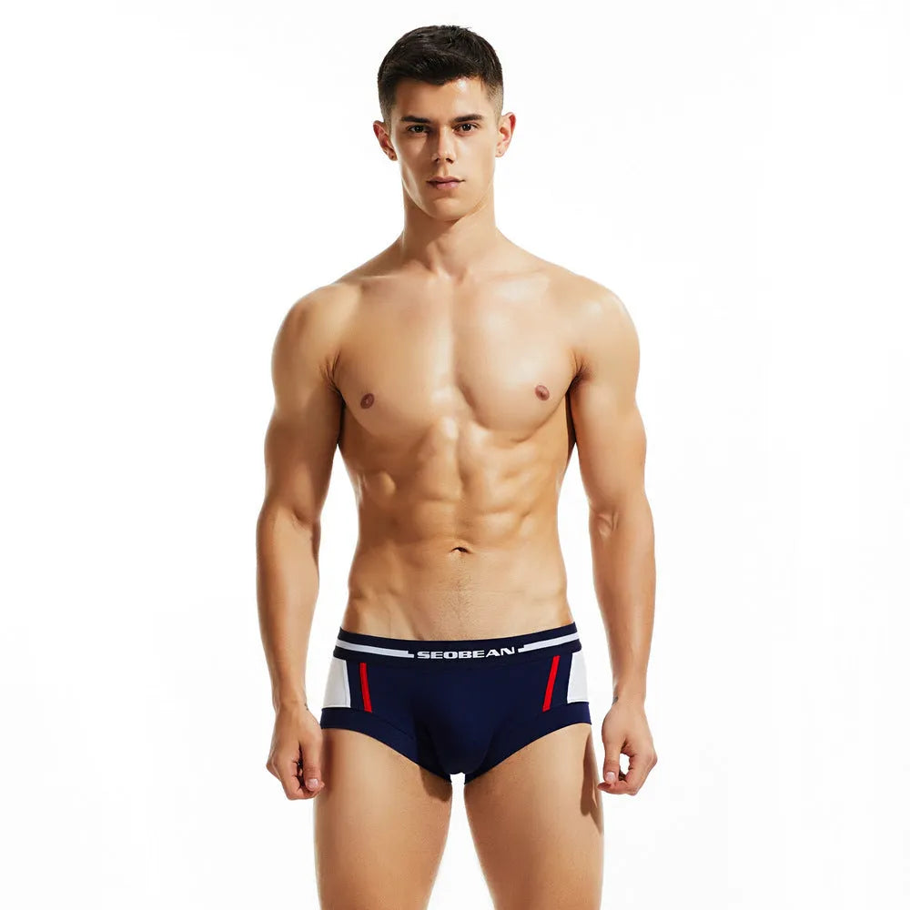 Men's cotton boxers in red, dark blue, and light grey showing low-waist design.