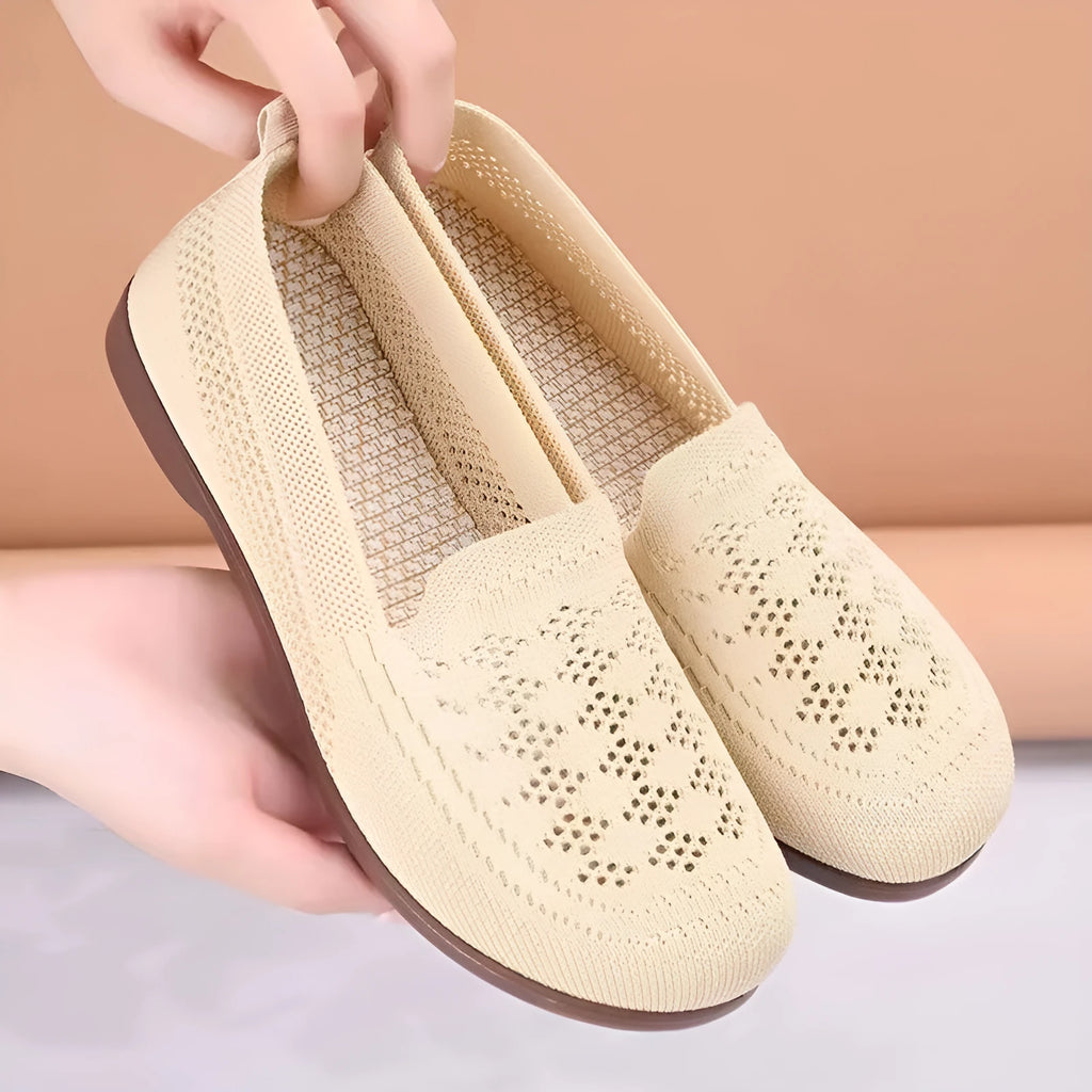 Beige casual tennis shoes for women with mesh upper and antiskid sole on a plain background.