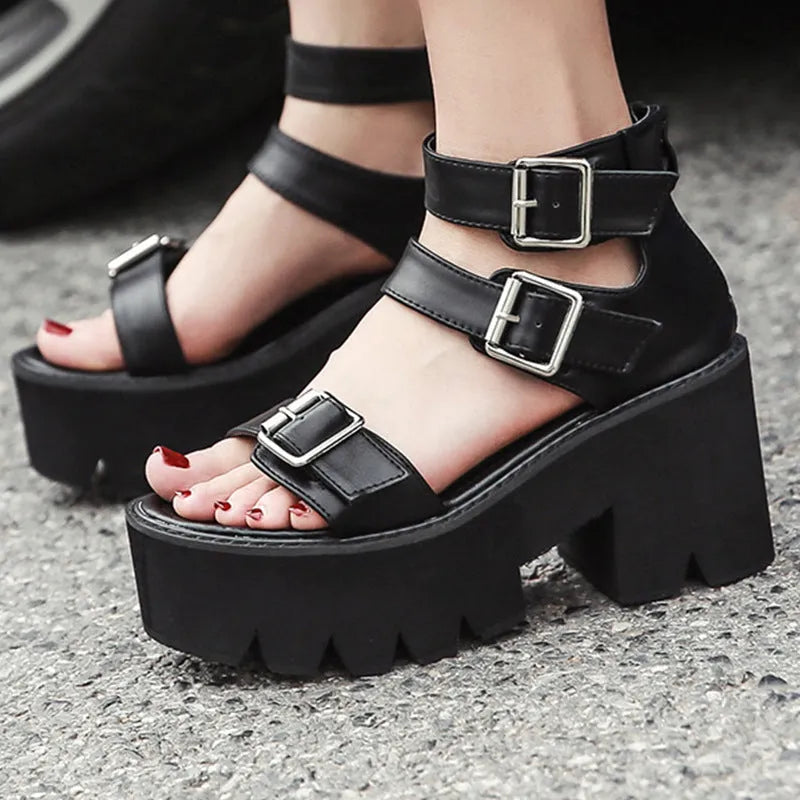 Black women's punk style platform sandals with chunky heel, round toe, buckle straps, and a rear zipper.