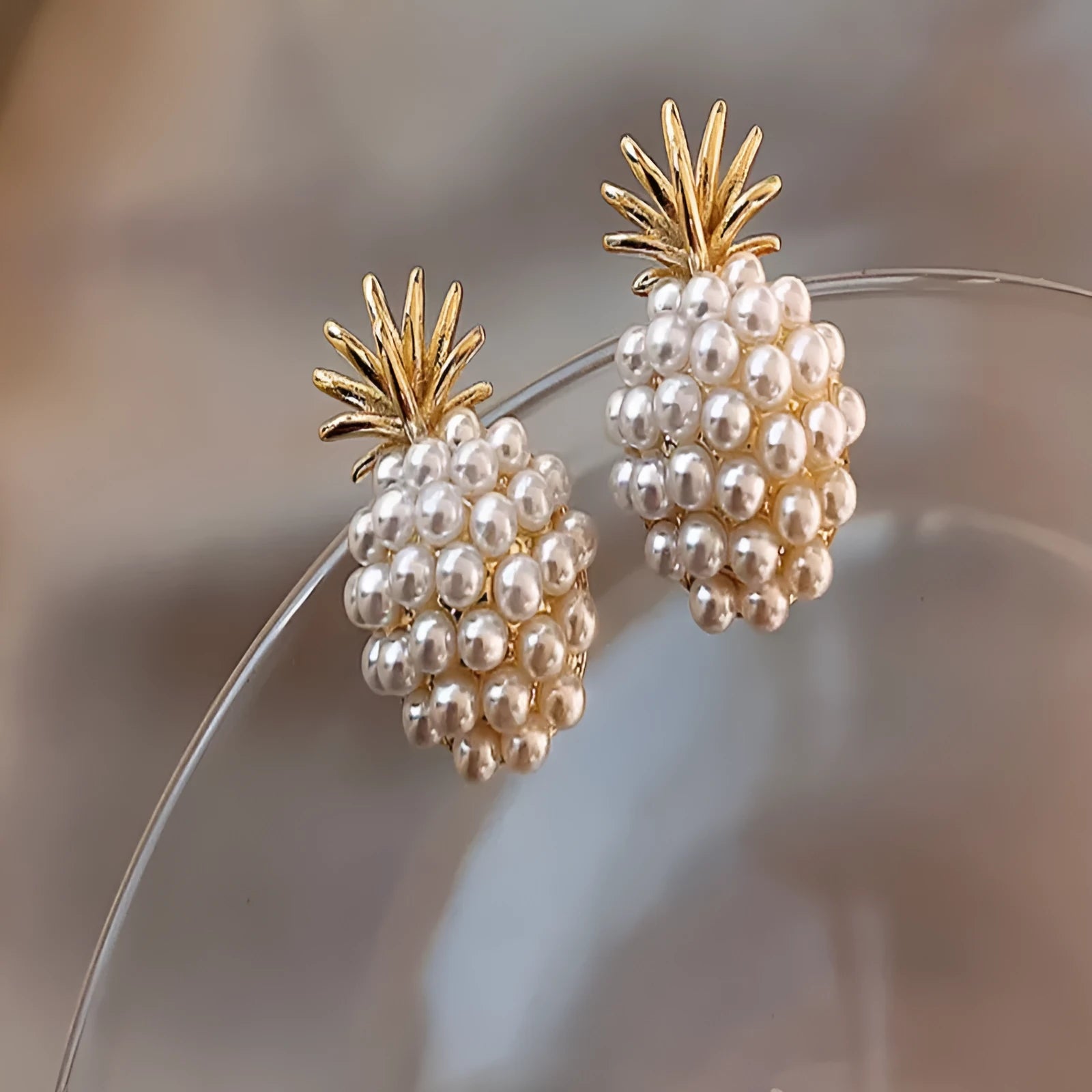 Women's gold Korean style alloy earrings with pineapple and starfish charms inlaid with artificial gems.