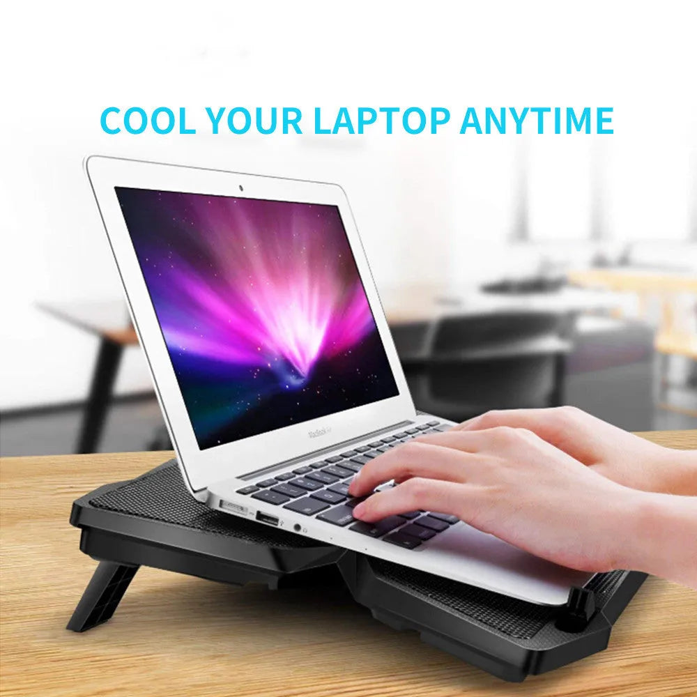Blue laptop cooling base with four LED fans and two USB ports on a desk.