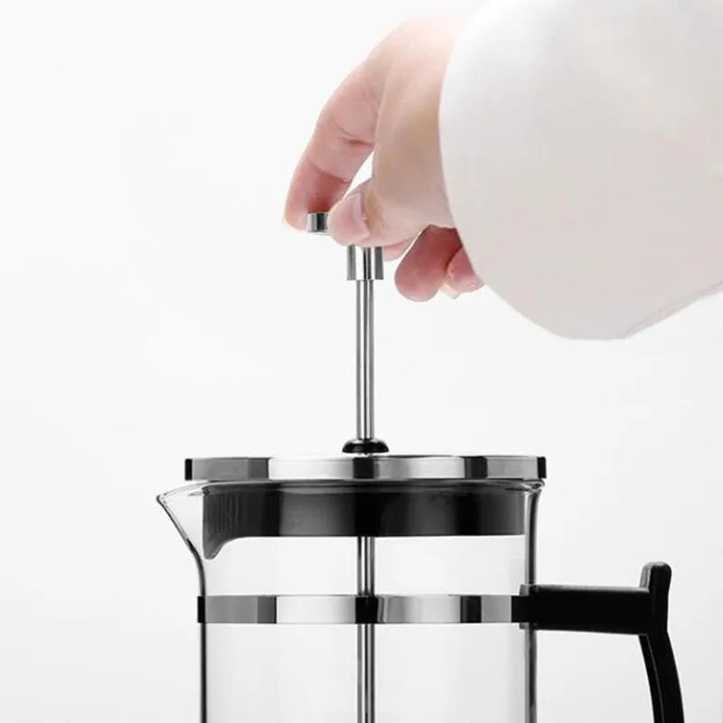 Compact glass French press coffee maker with stainless steel frame, 350ml capacity.