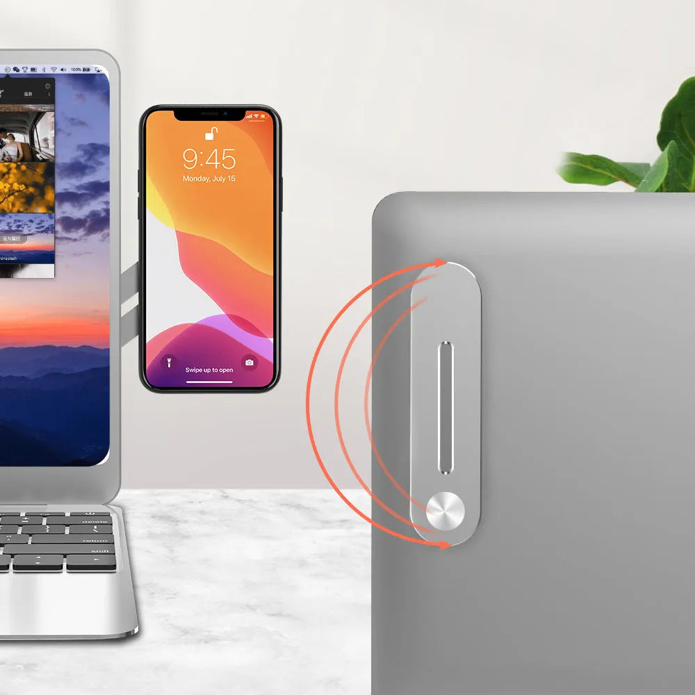 Silver aluminium laptop side mount bracket holding a smartphone, showing adjustable arm and magnetic pads.