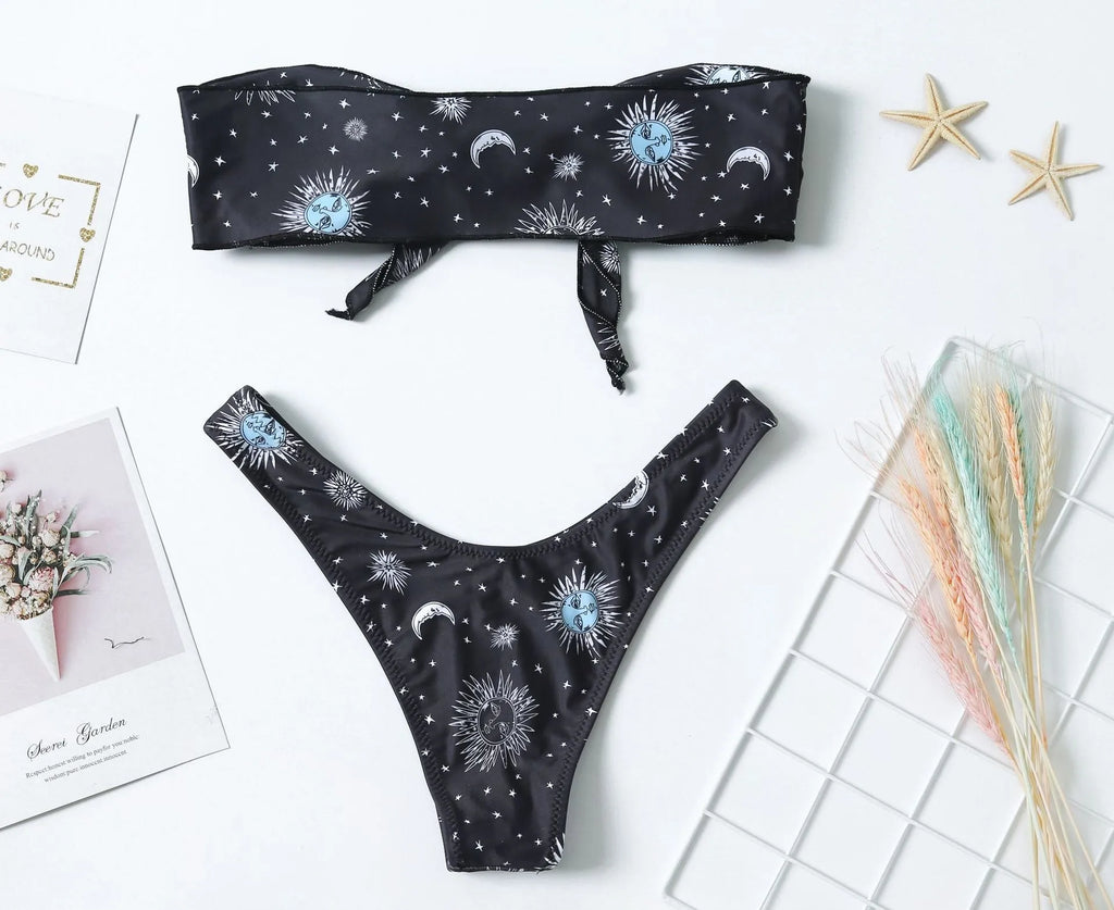 Black one-piece swimsuit with a printed bikini pattern, showing a split tube top and backless design.