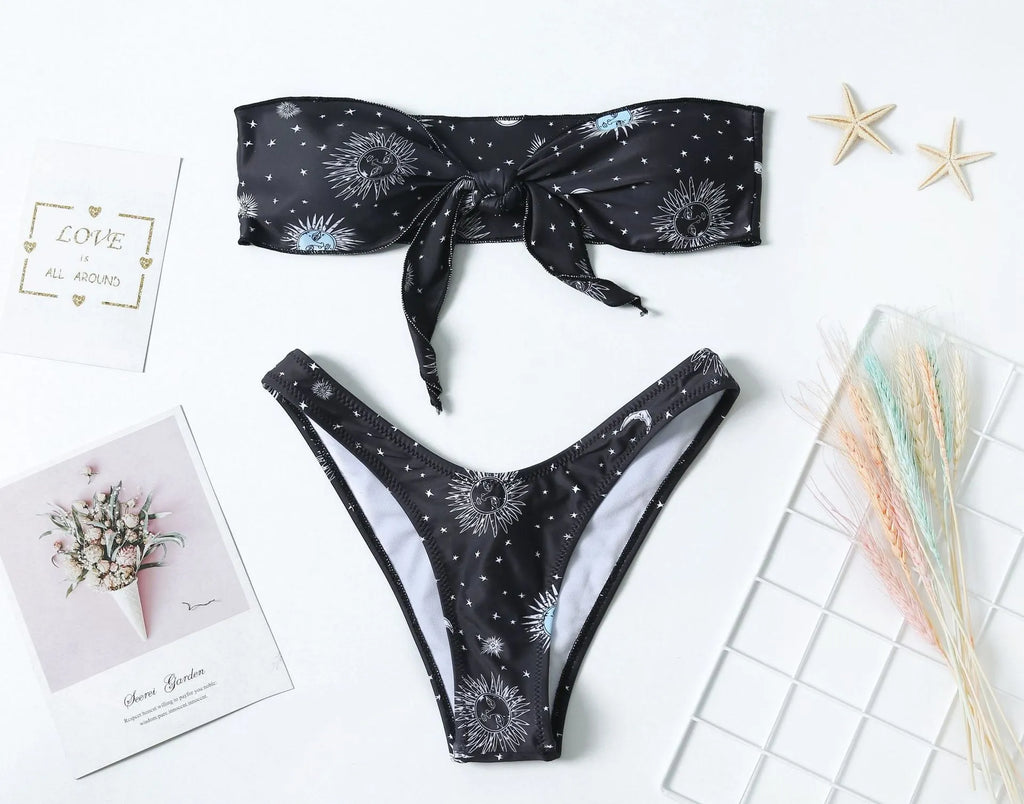 Black one-piece swimsuit with a printed bikini pattern, showing a split tube top and backless design.