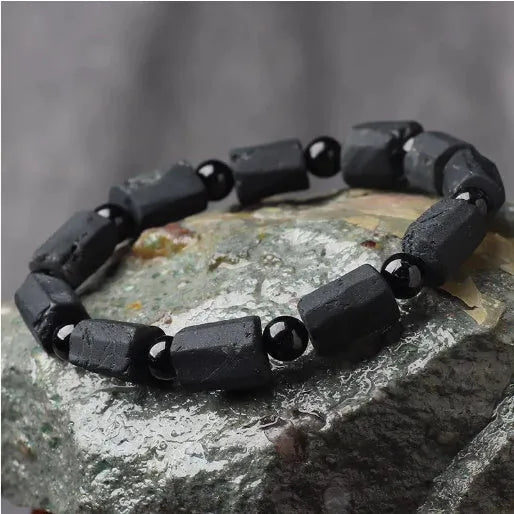 Natural black tourmaline rough stone bracelet with polished beads on wrist