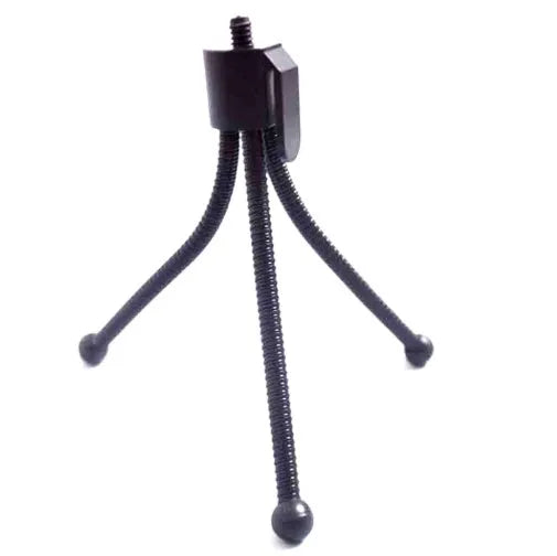 Compact black iron mini tripod with ball head, folded next to an iPhone for scale.