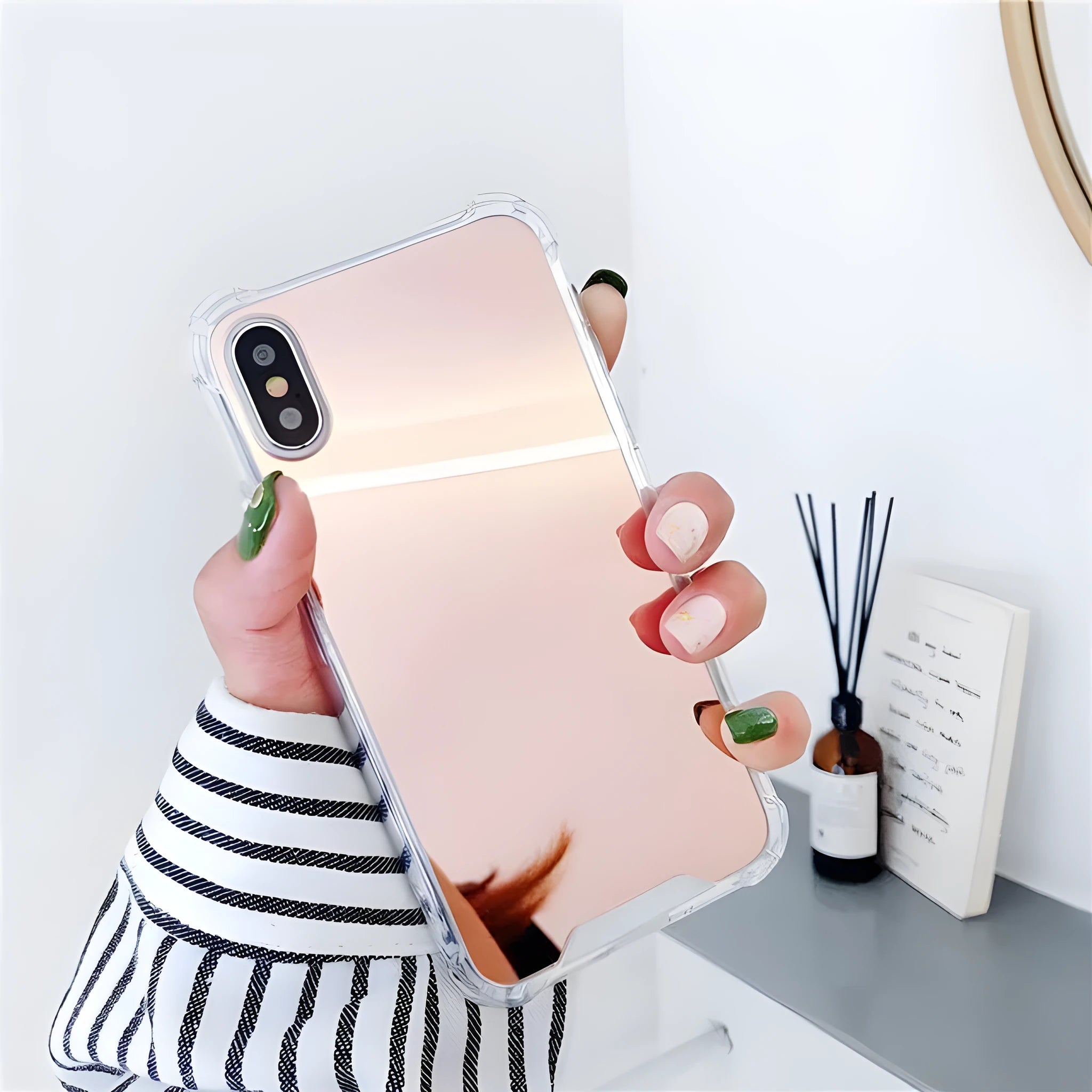 TPU mirror phone case for iPhone on a table, showing anti-fingerprint finish.