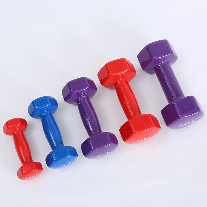 Colourful plastic fitness dumbbells in 0.5kg, 1kg, and 1.5kg weights with glossy surface