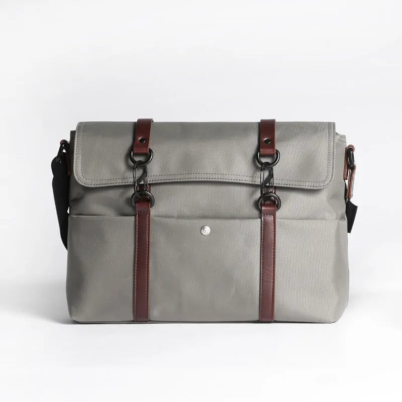 Men's black waterproof tote bag with cross-section square shape, matte finish, and soft handle, designed for 13-inch laptop and business travel