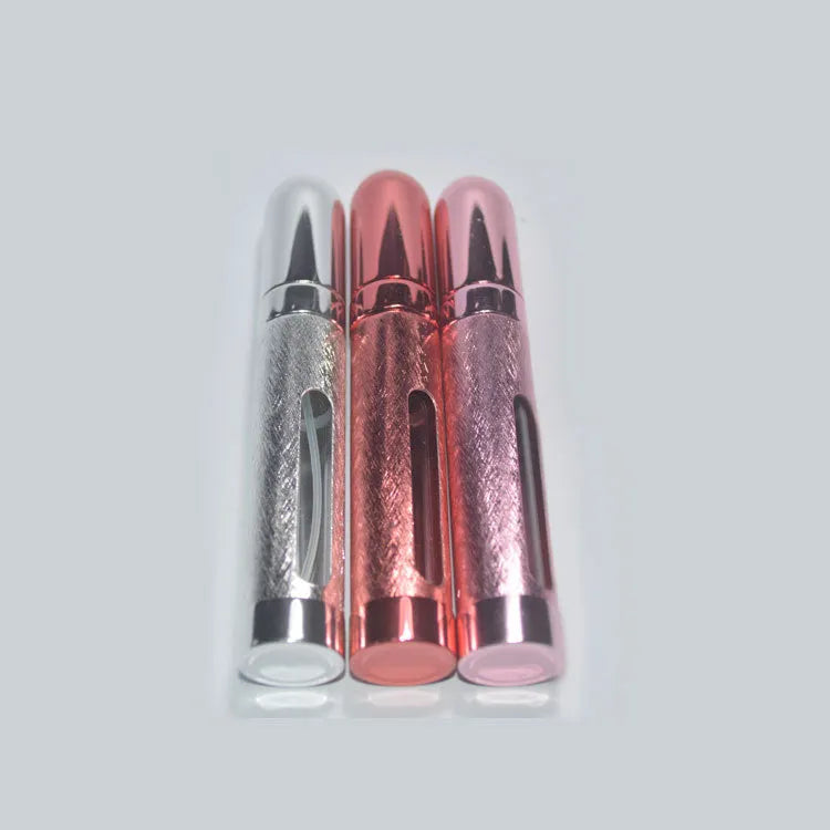 Refillable aluminium travel perfume atomiser with glass liner in blue, gold, pink, red, silver, or violet.
