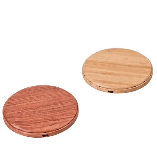 Natural bamboo wireless charger pad on desk with a smartphone placed on it