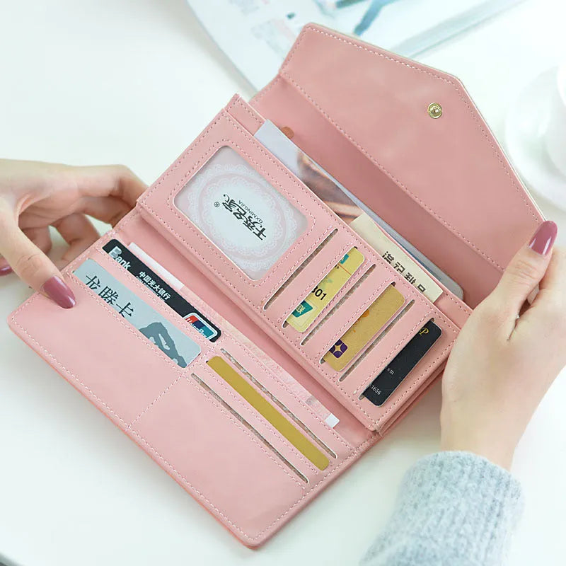 Women's large capacity three-fold PU leather student wallet with buckle closure in multiple colours.
