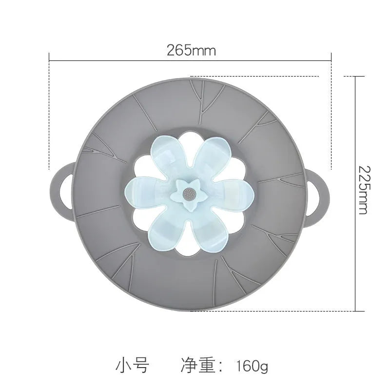 Silicone spill-proof pot cover in black, size 30x26cm, resting on a pot